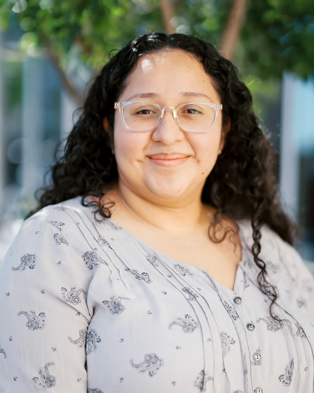 Perla Abeyta, Licensed Marriage and Family Therapist, smiling outdoors in the Texas sunshine